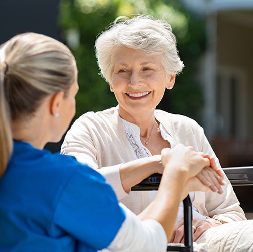 Elderly-Woman-In-Wheelchair-Talking-To-Therapist.jpg