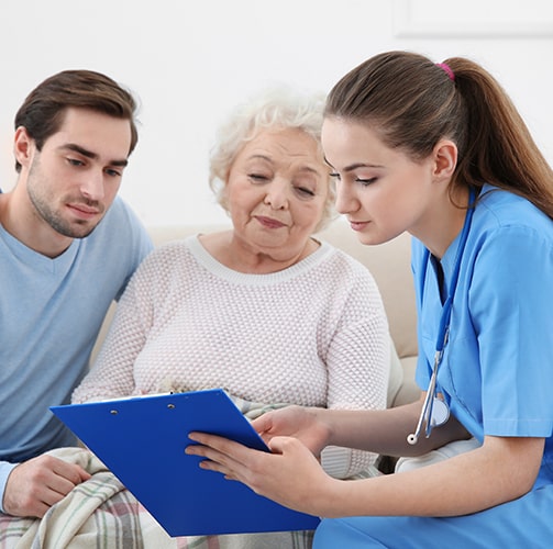 Elderly-Woman-And-Son-Looking-At-Chart-With-Doctor.jpg